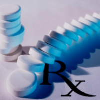 Pill tablets stacked and the word Rx