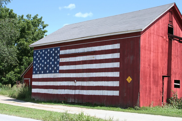 American flag painted on the side of a red barn