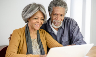 Elderly couple looking at a laptop