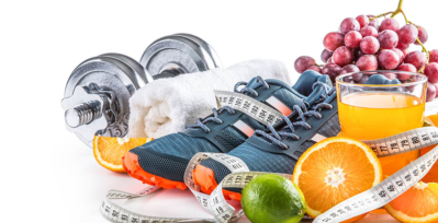 Weights, towel, grapes, tennis shoes, measuring tape, juice, and sliced oranges.