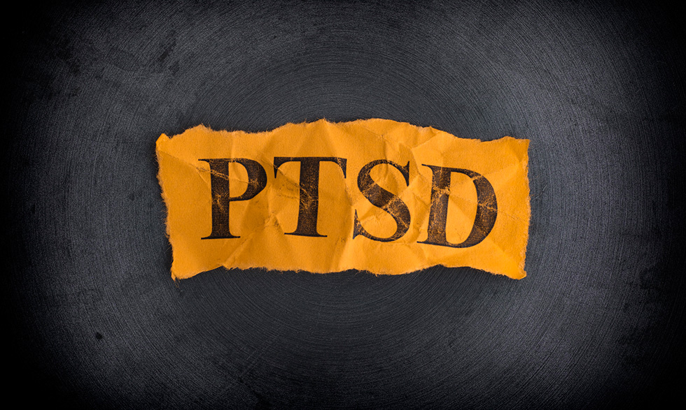 Crumpled paper stamped with "PTSD"