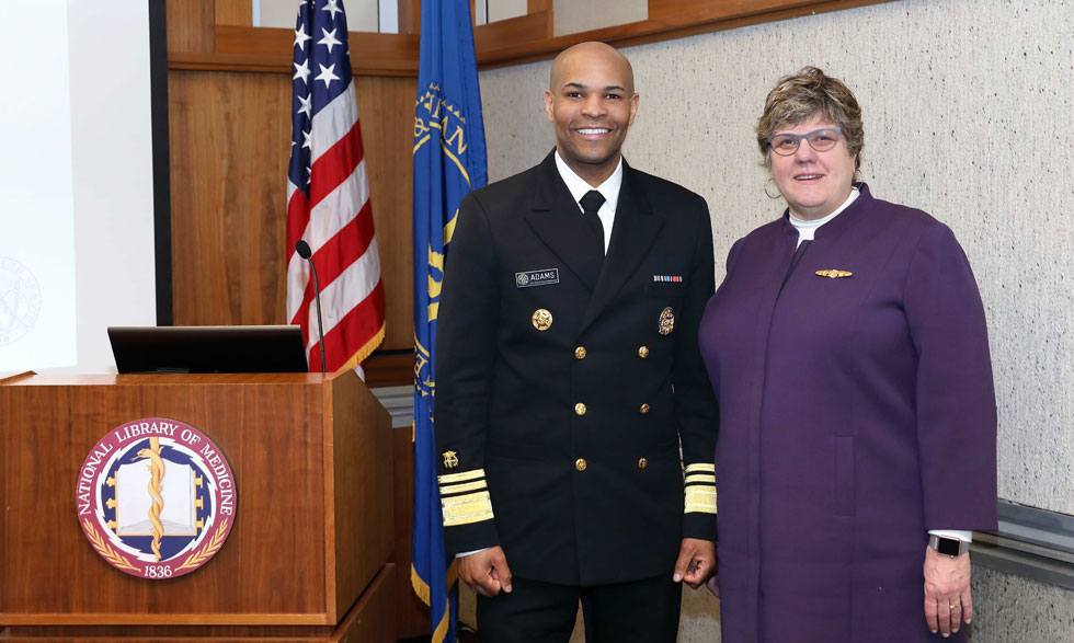 Surgeon General and Vice Admiral Jerome M. Adams with NLM Director Patricia Flatley Brennan, R.N., Ph.D.