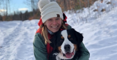 Headshot of Heather Quintal hugging her saint bernard