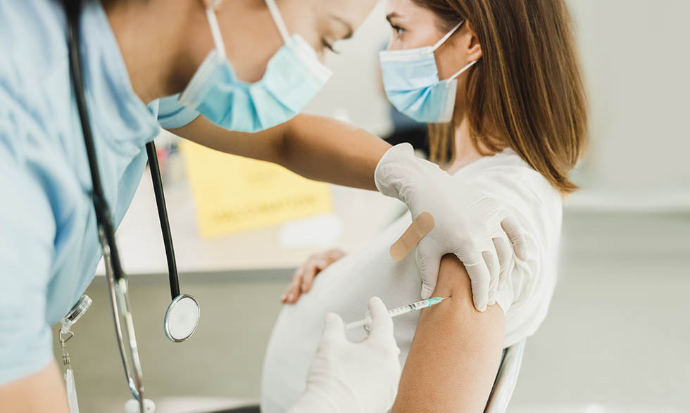 Pregnant woman getting vaccine shot